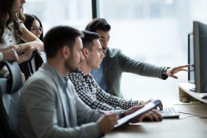 People working together at a desk.