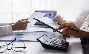 Team of Business people working at workplace with tablet and document, doing planning analyzing Tax financial report, business plan investment, finance analysis Economic business discussions. stock photo