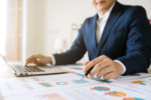 Man working over charts and numbers