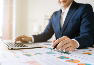 Man working over charts and numbers