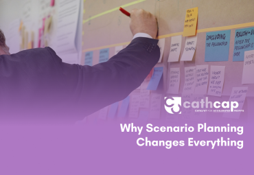 Law firm owner reviewing three financial scenarios with a fractional CFO, analyzing best case, base case, and stress case projections