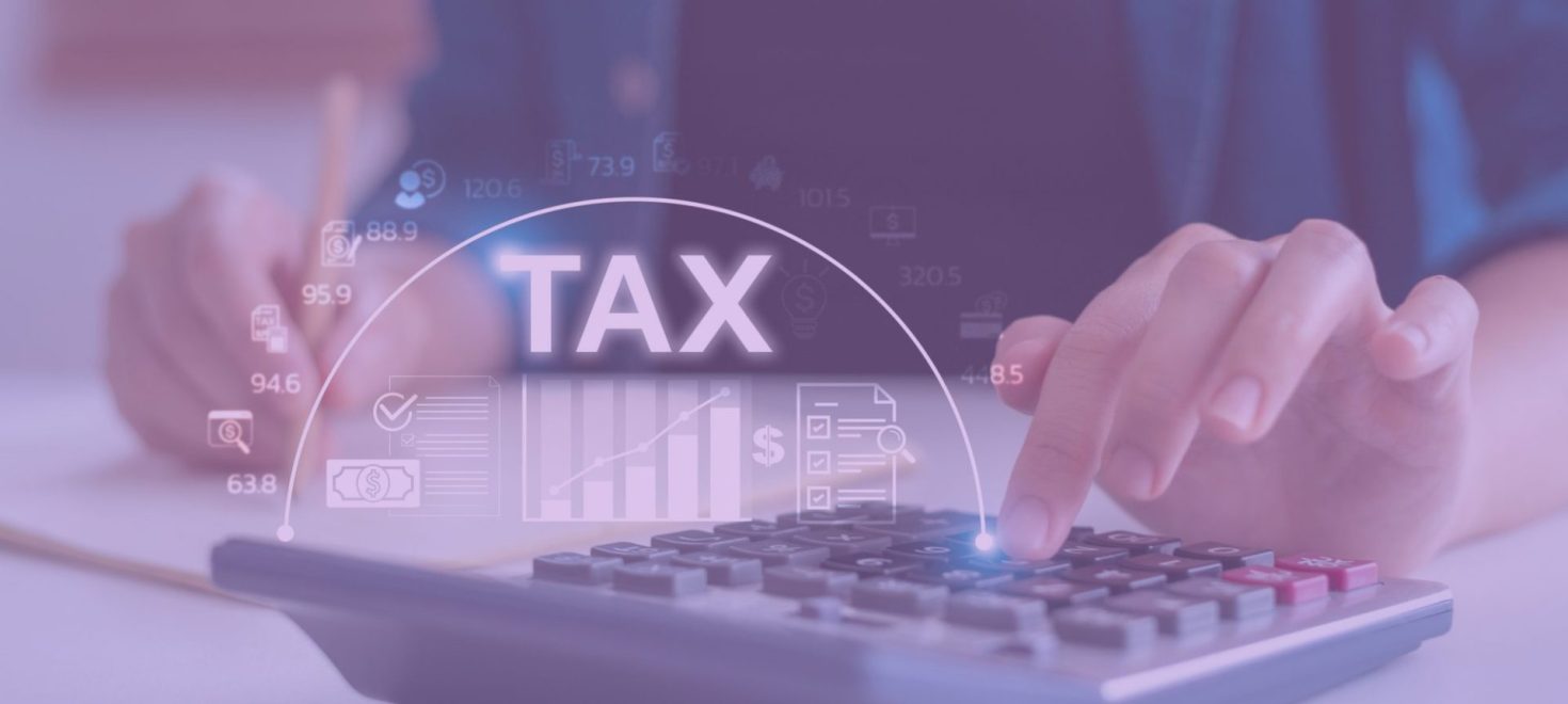 someone plugging in numbers on a calculator around tax time