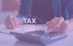 someone plugging in numbers on a calculator around tax time