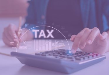 someone plugging in numbers on a calculator around tax time