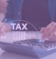 someone plugging in numbers on a calculator around tax time