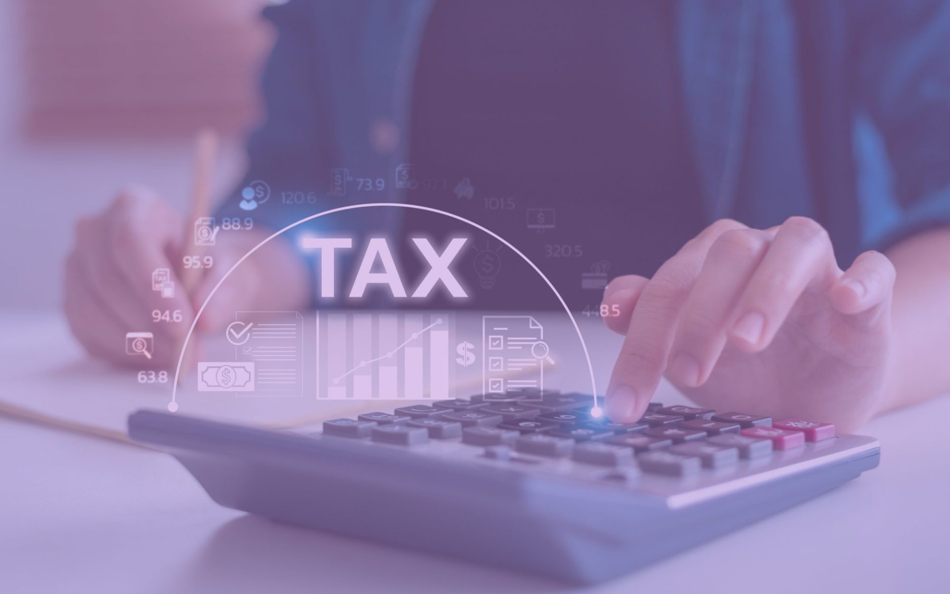 someone plugging in numbers on a calculator around tax time