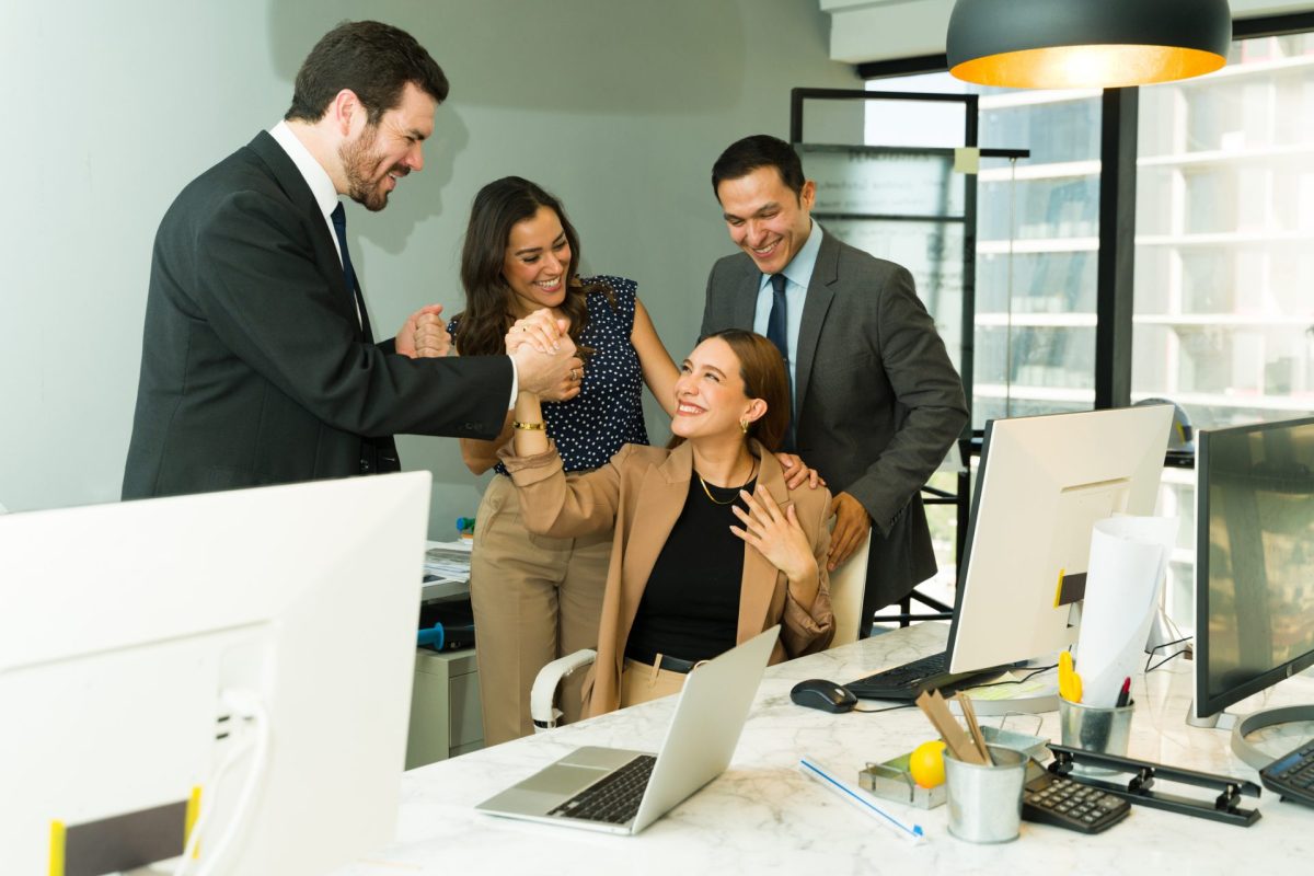 People around a desk celebrating