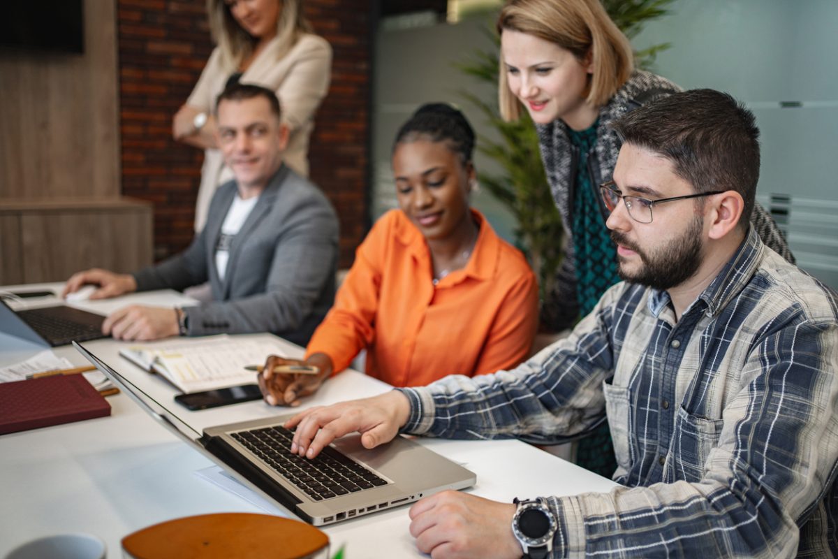 Multiracial group of business people brainstorming together at the office