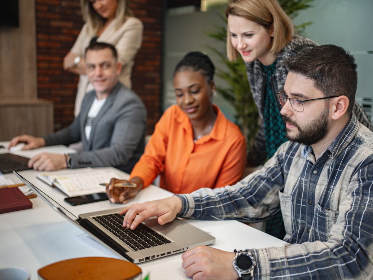 Multiracial group of business people brainstorming together at the office