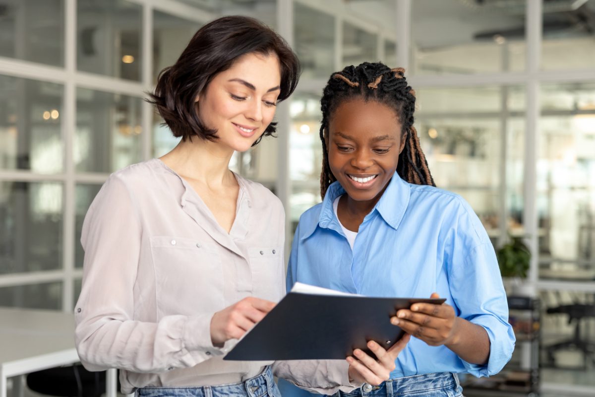 Colleagues discussing about project in modern office