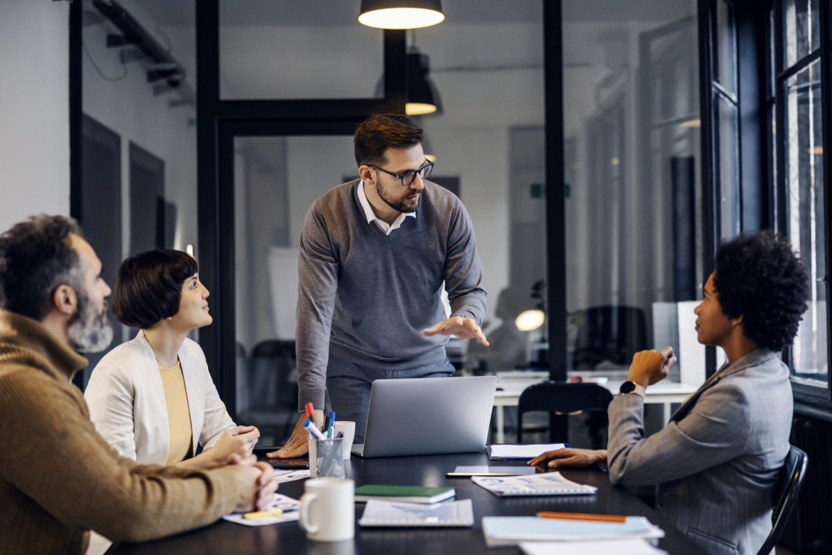 A focused businessman is having presentation about project at the office.